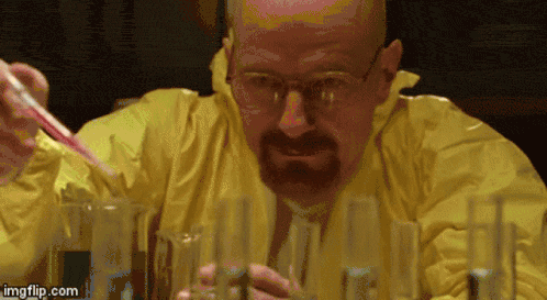 GIF de la série Breaking Bad : le personnage Walter White, en combinaison de chimie, verse un liquide dans des bec Bunsen.